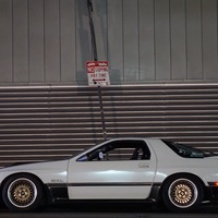 White 1987 Mazda RX-7 on Gold Ford Crown Victoria